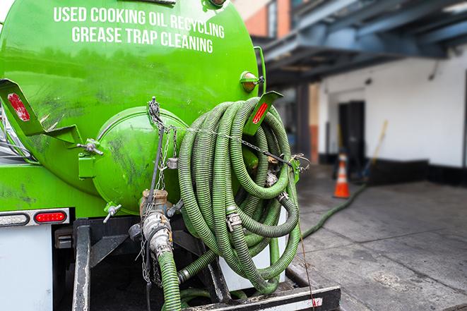 a vacuum truck pumping out a large underground grease trap in Ecorse, MI